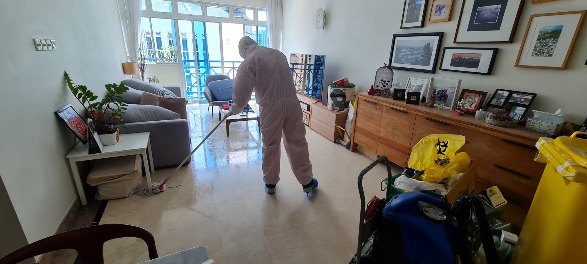 Technician applying disinfection treatment to an air conditioning vent in a commercial building