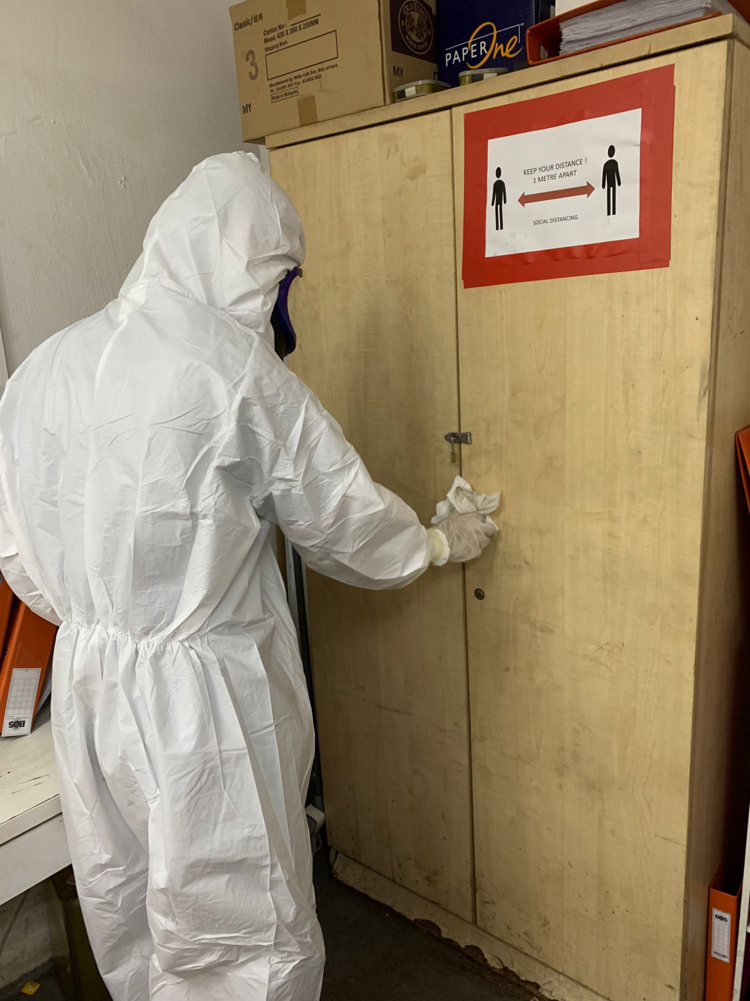 Technician applying surface coating to commercial gym equipment