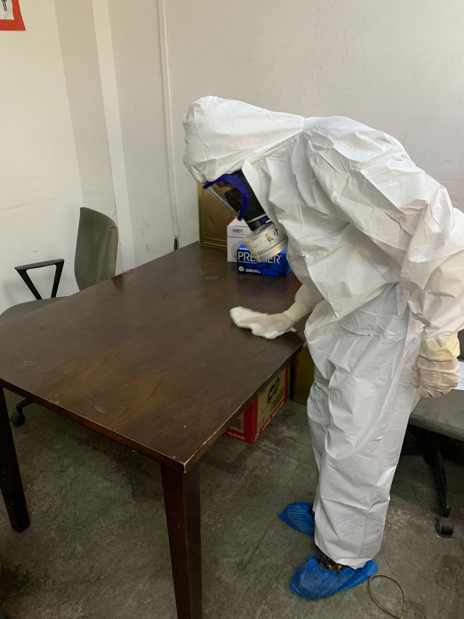 Technician applying surface coating to a preschool classroom table